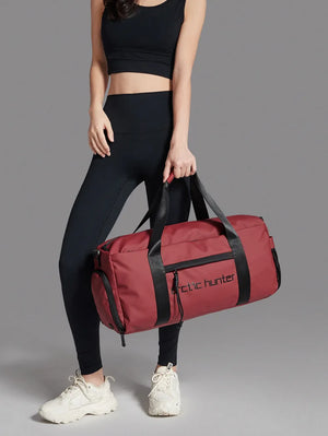 Red waterproof duffle sports bag with wide handles, side pockets, and zip front