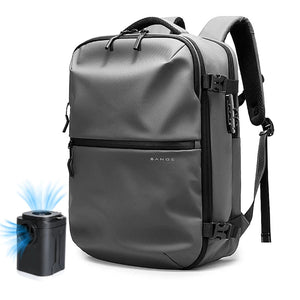 Grey waterproof travel backpack with pump, front zipper pocket and padded shoulder strap.