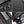 Black toiletry bag detail: metal zipper pulls, brand logo, and inner pocket compartments.