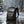 Black waterproof commuter backpack standing in rain with water droplets on fabric