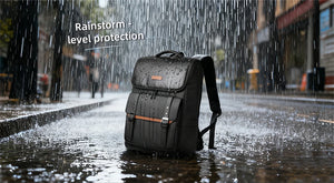 Black waterproof commuter backpack standing in rain with water droplets on fabric