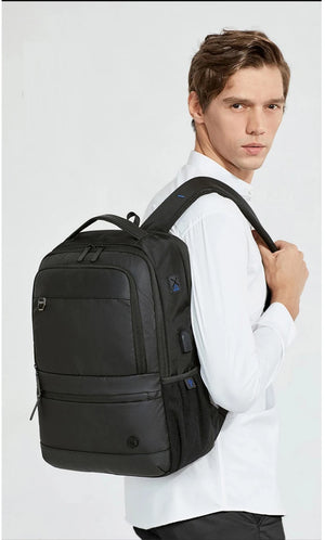 Black large travel backpack with multiple front pockets and side carry handle