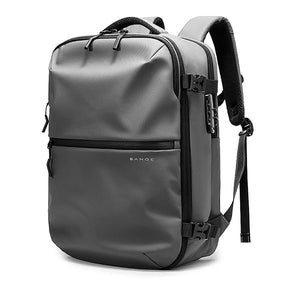 Gray waterproof travel backpack with top handle, front zip pocket, and adjustable side shoulder strap