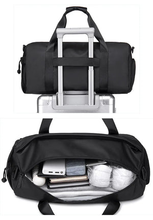 Black waterproof duffle bag with luggage-style handle and open interior storage