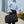 Black waterproof duffle and sports bag carried with top handles and shoulder strap