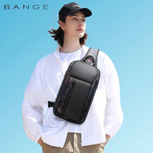 Dark gray waterproof crossbody sling bag worn across chest with front pocket and strap