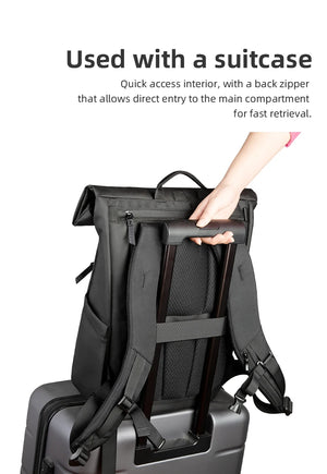 Black backpack with luggage strap for attaching to a suitcase