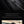 Black backpack with hidden card slot pocket and USB charging cable pass-through