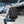 Black travel backpack worn on back with front straps and zip compartments