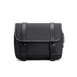 Compact crossbody bag with curved flap, two buckled straps, textured dark body
