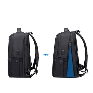 Black waterproof travel backpack, rear view with blue accent panel and padded straps