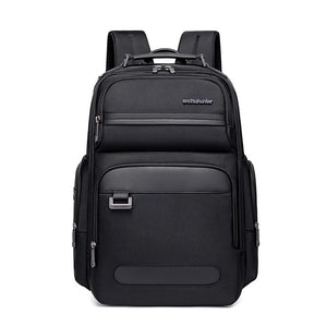 Black waterproof travel backpack with front zip pocket and top carry handle.
