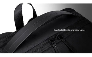 Black waterproof travel backpack top handle and zipper close-up