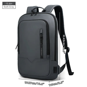 Dark gray compact waterproof backpack with front pocket, side strap, and USB port panel