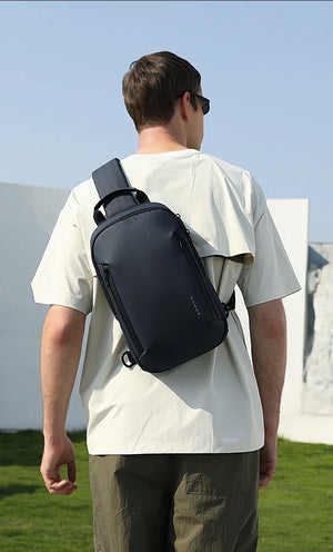 Lightweight waterproof crossbody bag, dark blue, worn across chest with shoulder strap