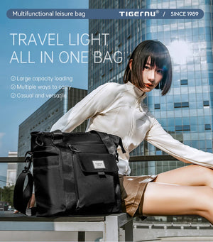 Black waterproof backpack with front flap and shoulder strap, carried outdoors