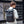 Grey roll-top waterproof backpack worn on back with adjustable shoulder straps