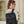 Black compact commuter backpack with front flap, front zipper, and adjustable shoulder straps