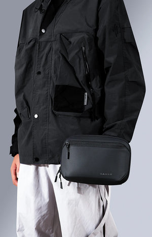 Black tech storage bag with front zip pocket and side access