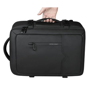 Black travel backpack with top handle, front zip pocket, and locking clips