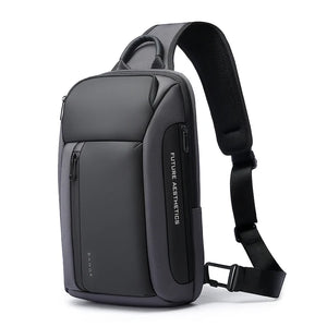 Dark gray compact waterproof crossbody bag with padded shoulder strap and front zip pocket