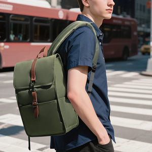 Green commuter backpack worn on back, side view with brown handle accents