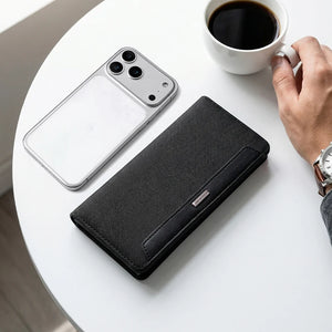 Black long bifold wallet with textured fabric and slim front tab detail.