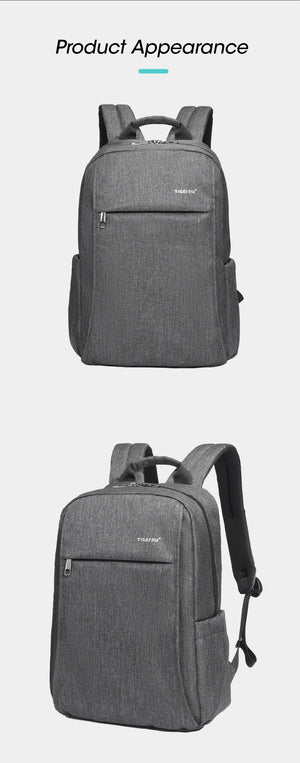 Grey compact backpack with top handle, front zipper pocket, and side details