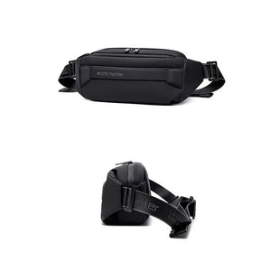Black crossbody bag shown front and side; padded body with top handle loop and strap.