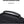 Black waterproof travel backpack close-up of textured fabric and top carry handle