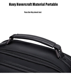 Black waterproof travel backpack close-up of textured fabric and top carry handle