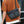 Black waterproof messenger bag worn crossbody with flap and front buckle closure
