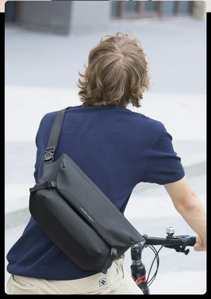 Black crossbody bag back view with adjustable strap and rear flap