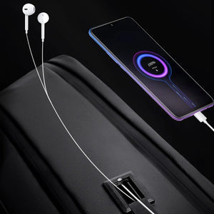 Black travel backpack with built-in charging port and cable pass-through zipper area
