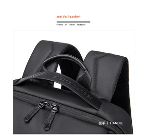 Black waterproof travel backpack with padded top handle and zippered front pocket