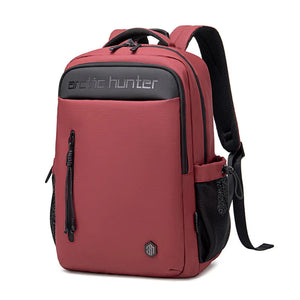Red travel backpack with front zipper pocket, padded back, and adjustable shoulder straps