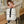 Beige compact waterproof commuter backpack with front buckle straps and zip pockets