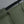 Green backpack left-side pocket for water cup storage next to bottle
