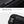 Black crossbody bag close-up of smooth zipper and adjustable shoulder strap buckle