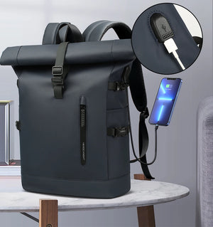 Dark roll-top waterproof backpack with built-in USB charging port and attached charging cable