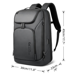 Large dark gray backpack with front zip pockets, top flap pocket, and padded shoulder straps
