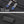 Black YKK zipper slider with smooth pull; reinforced bottom protective panel