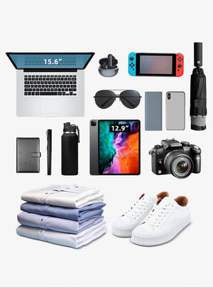 Black waterproof roll-top backpack shown packed with travel items and electronics