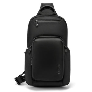 Black compact crossbody bag with top handle, front flap pocket, and side zippers