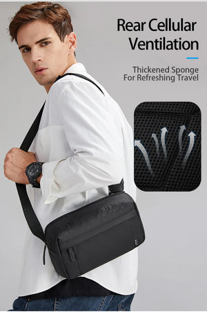 Black crossbody bag worn at side with textured panel on front and wide adjustable strap