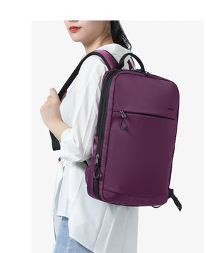 Purple compact waterproof backpack with top handle and zippered front pocket