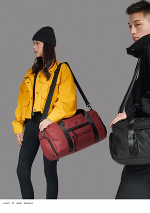 Red waterproof duffle bag with shoulder strap and front zip pocket