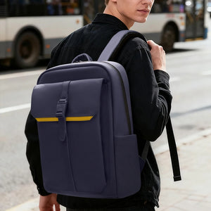 Navy waterproof commuter backpack worn with padded straps and front pocket