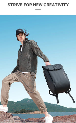 Grey roll-top travel backpack carried on side with front flap and adjustable straps