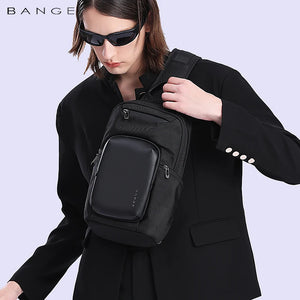 Black compact crossbody bag worn across the chest with adjustable shoulder strap